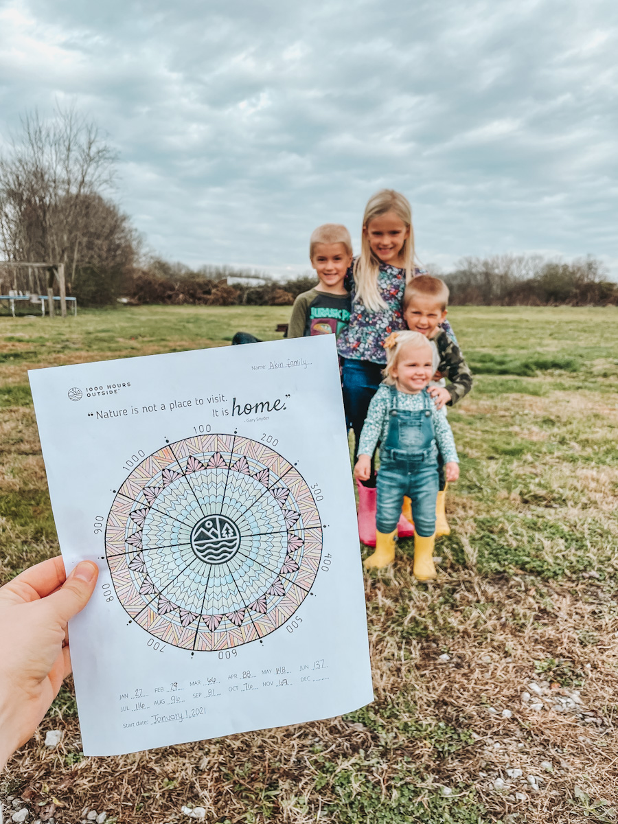 four kids standing together behind 1000 hours outside tracker