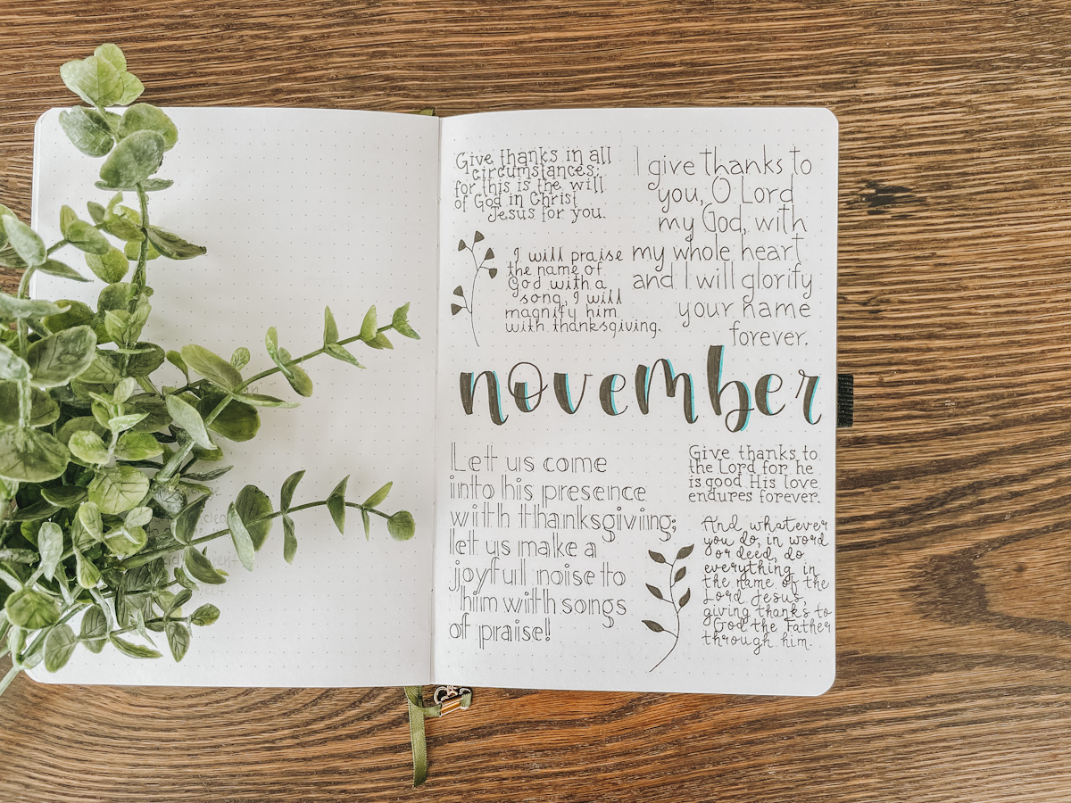 November bullet journal monthly spread with Bible verses about thankfulness written all over
