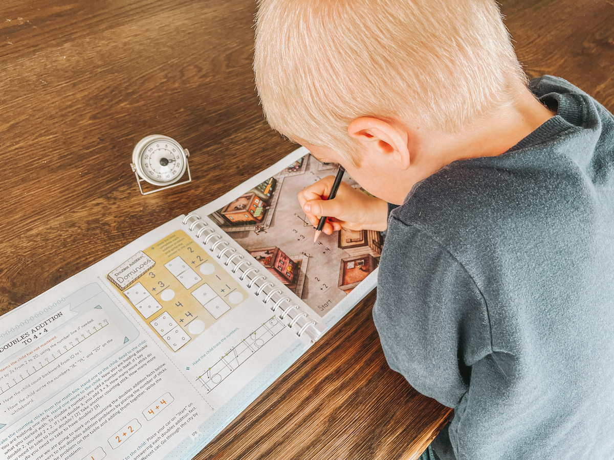 homeschool kindergartener completing math using a timer to help him focus