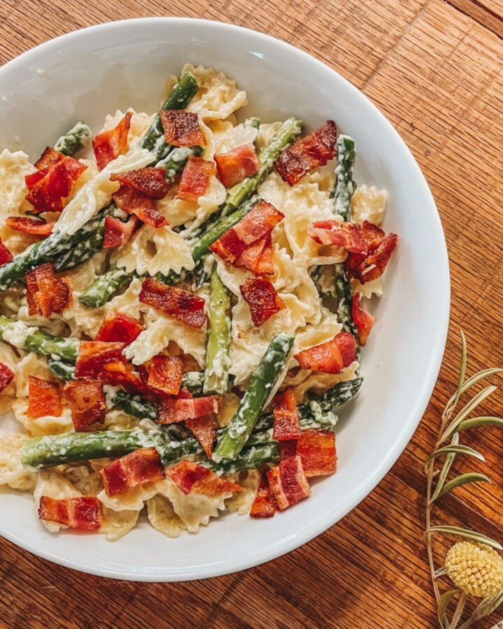 white bowl filled with creamy bacon asparagus pasta